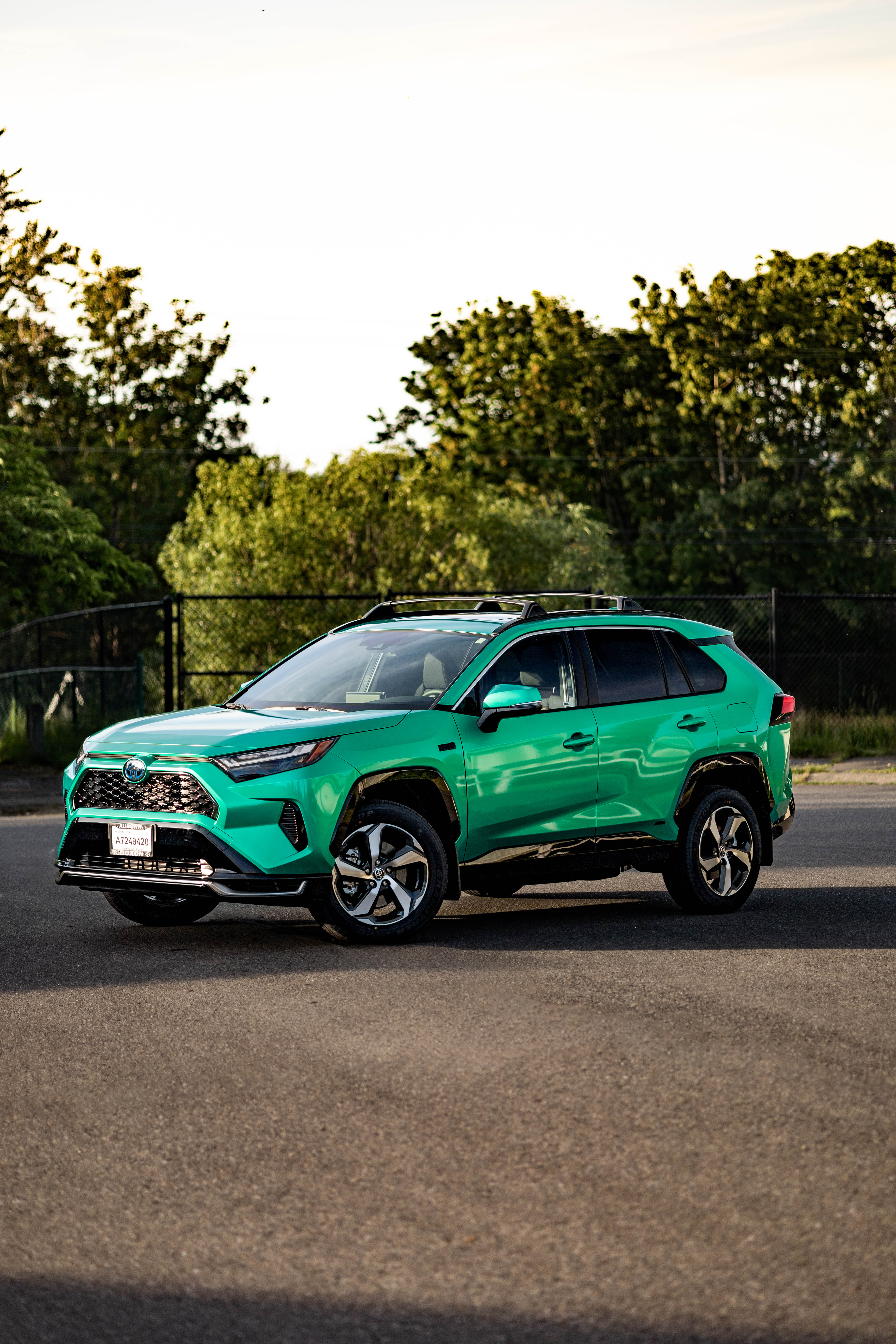Toyota RAV4 Prime in vibrant green KPMF wrap at golden hour