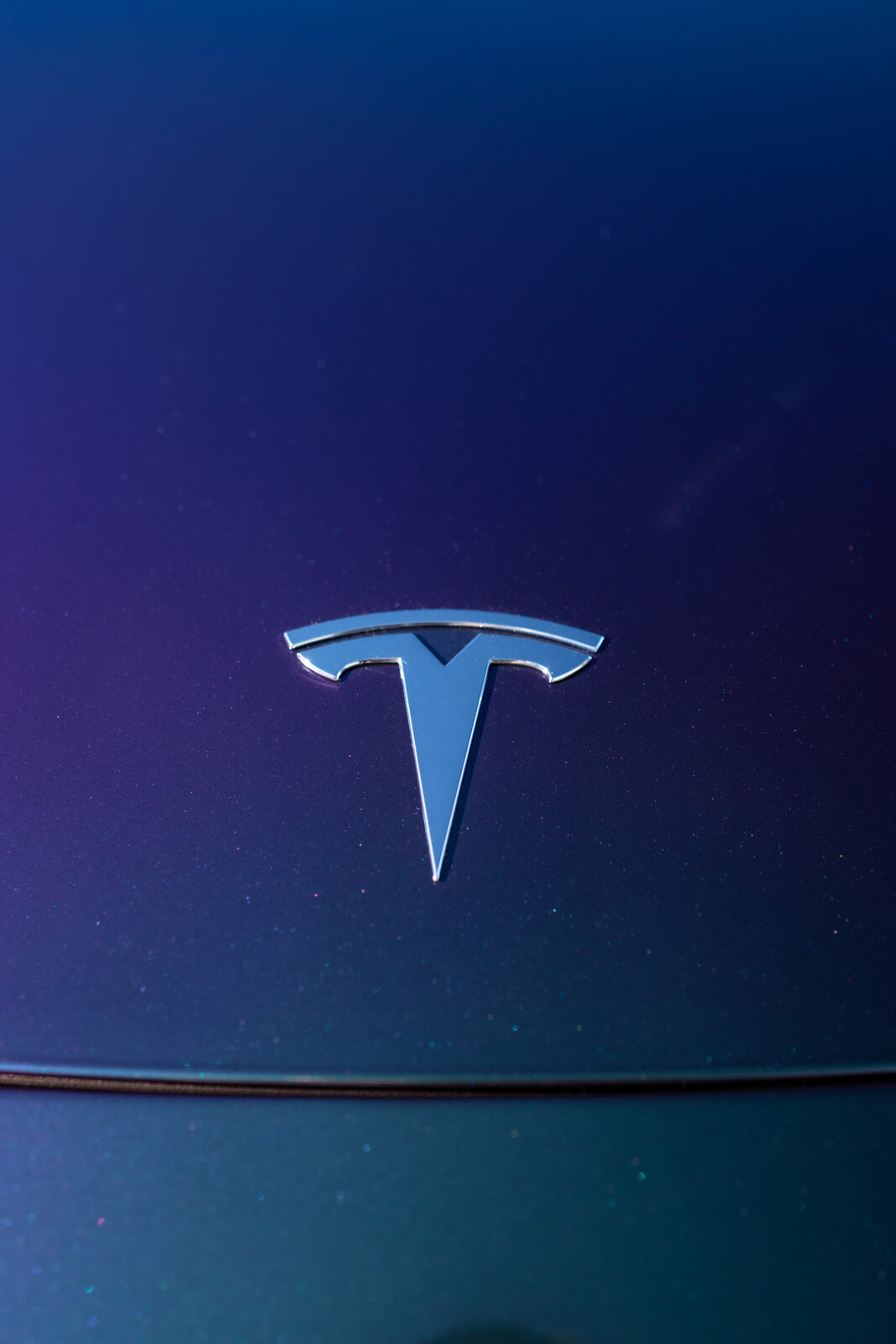 Close-up of a blue to purple color shift wrap film on a Tesla panel installed by SeaWraps