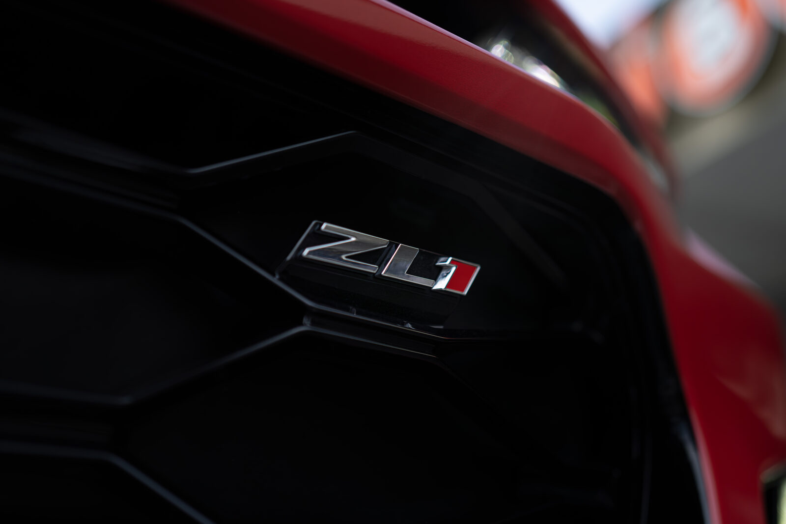 Badge and grille detail on a red Chevrolet Camaro ZL1 wrapped by SeaWraps