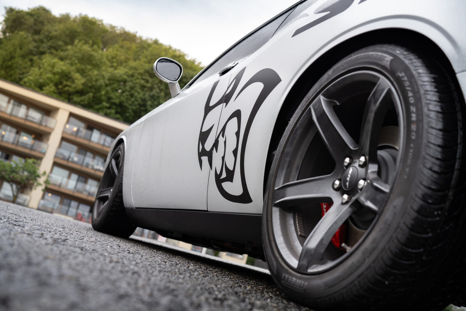 Close-up of vinyl graphics installed over a Dodge Challenger body panel by SeaWraps, showing the film running across a panel gap